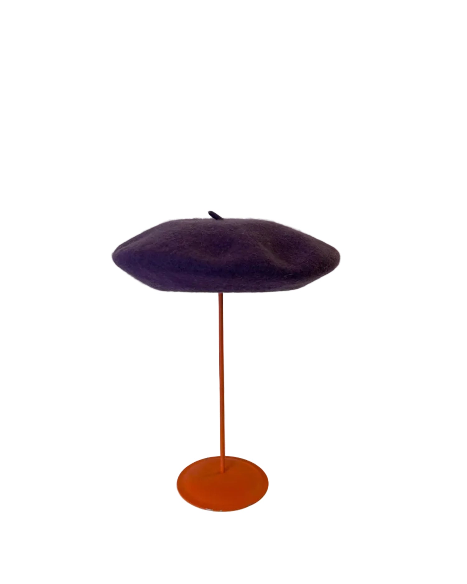 Purple Beret on a red stand against a white background