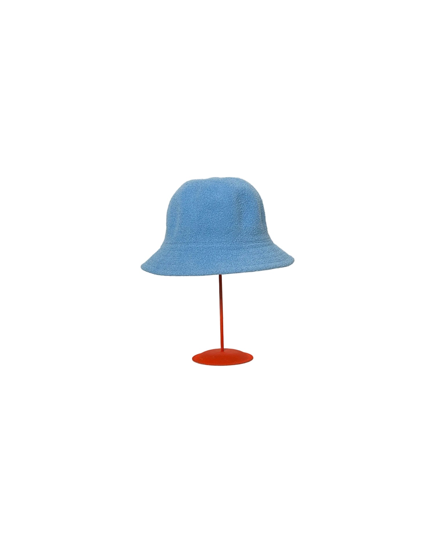 Blue Cloche hat on a red stand against a white backdrop.