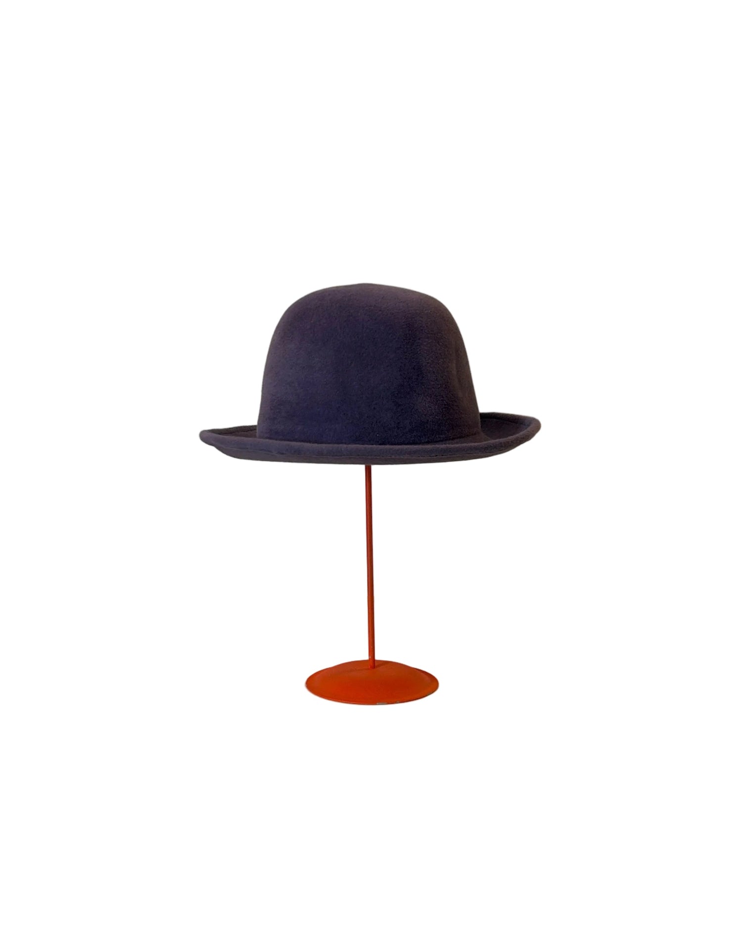 Purple Bowler hat on a red stand against a white background
