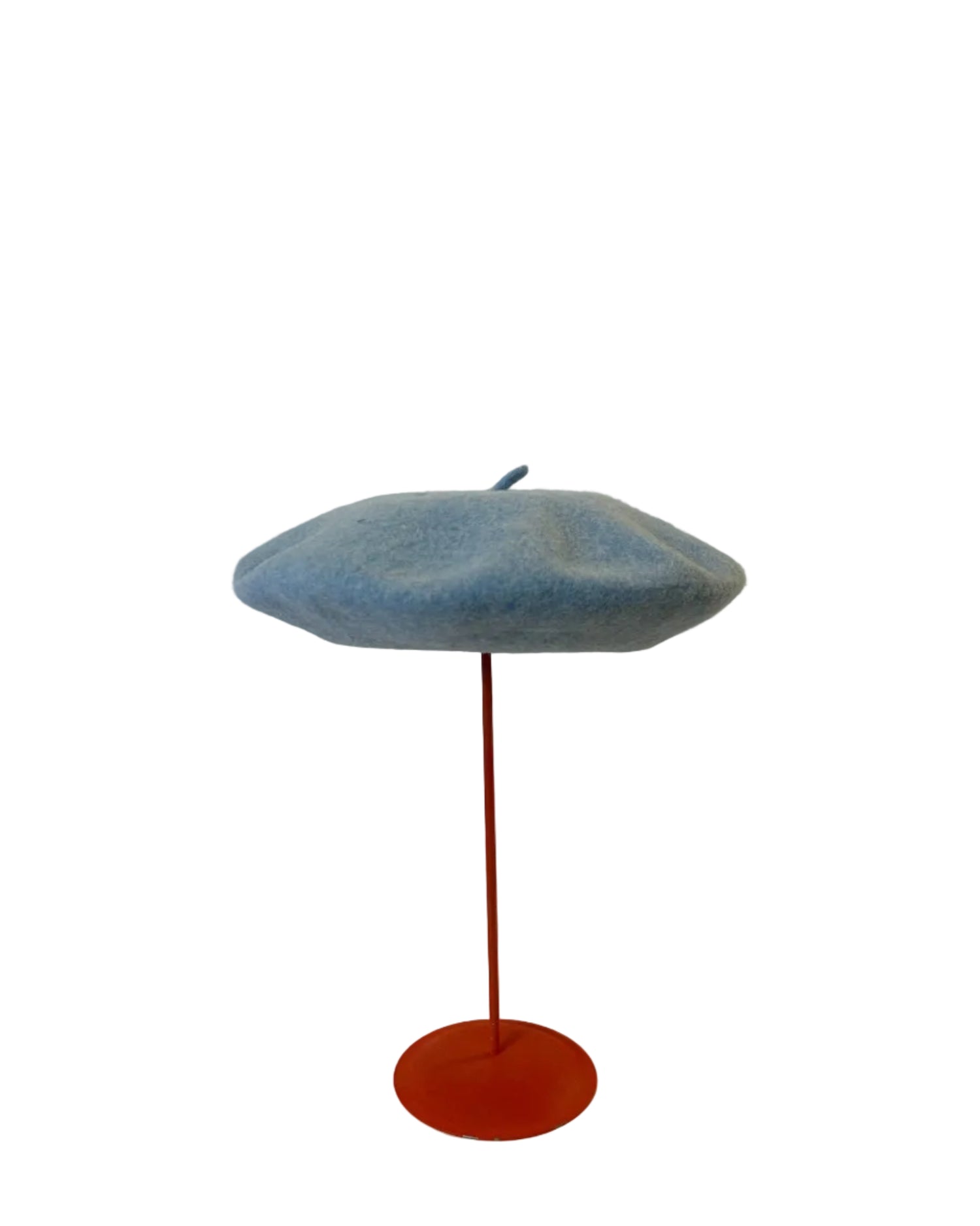 Blue Beret on a red stand against a white background