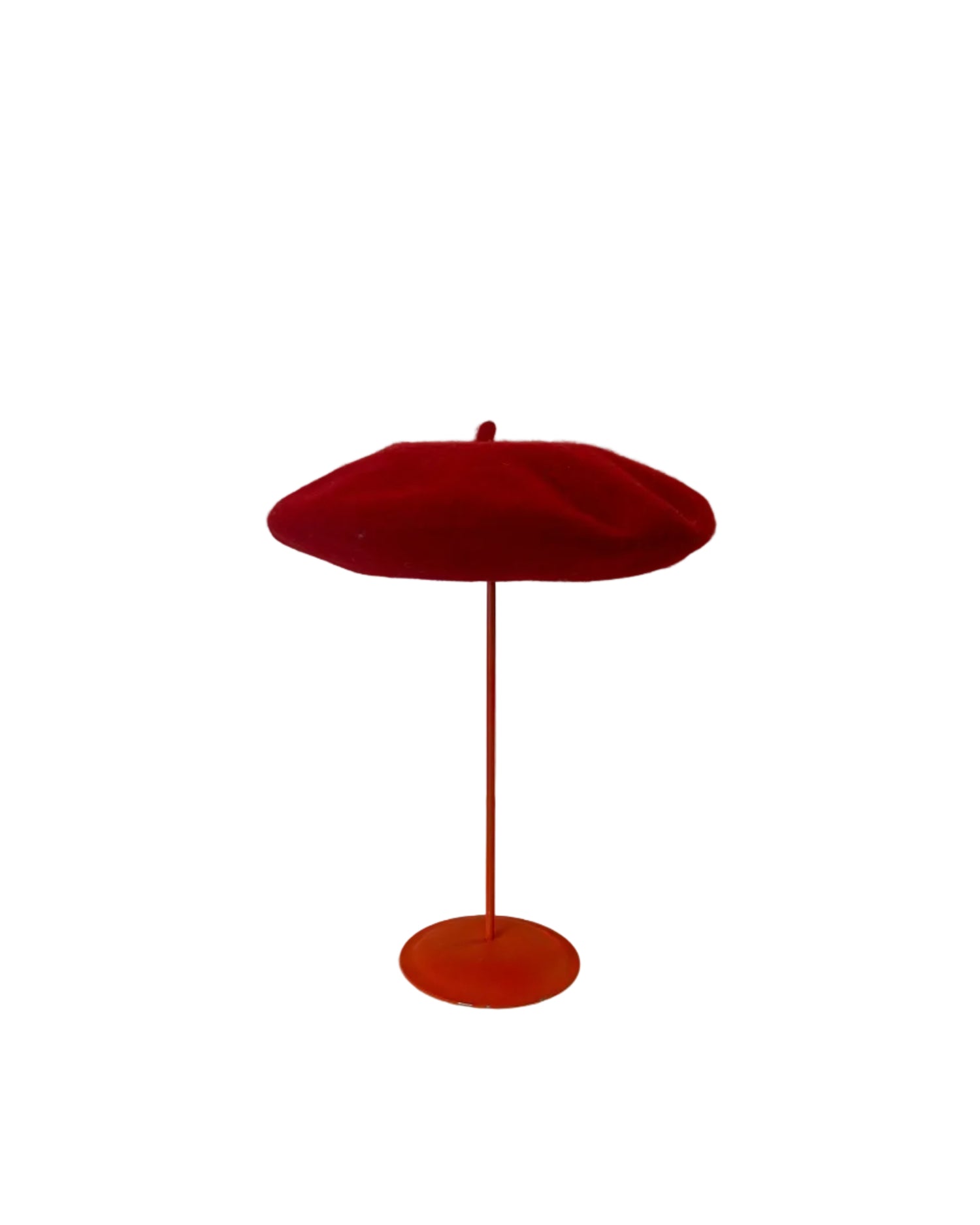 Red Beret on a red stand against a white background