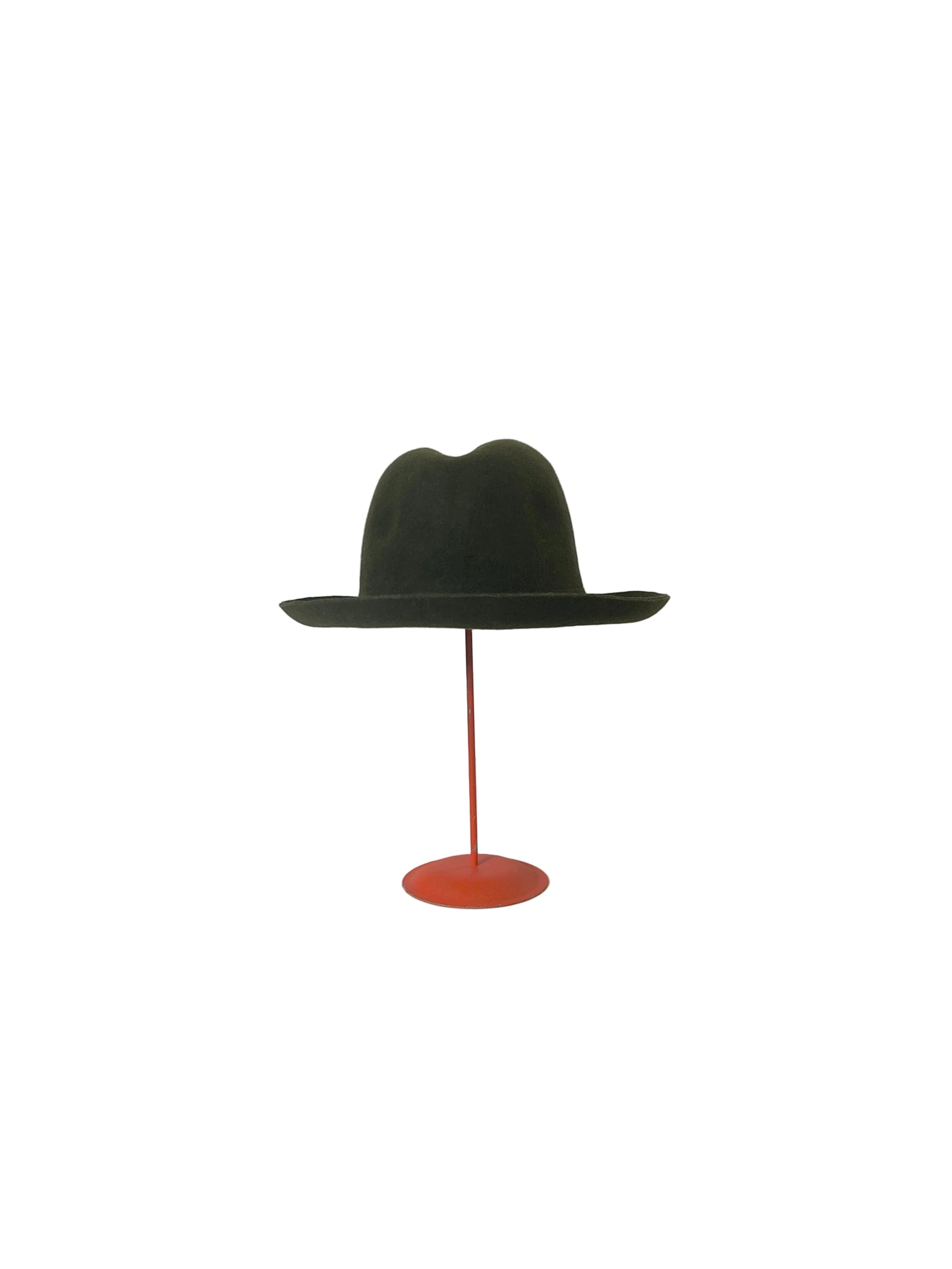 Green fedora hat on a red stand against a white background