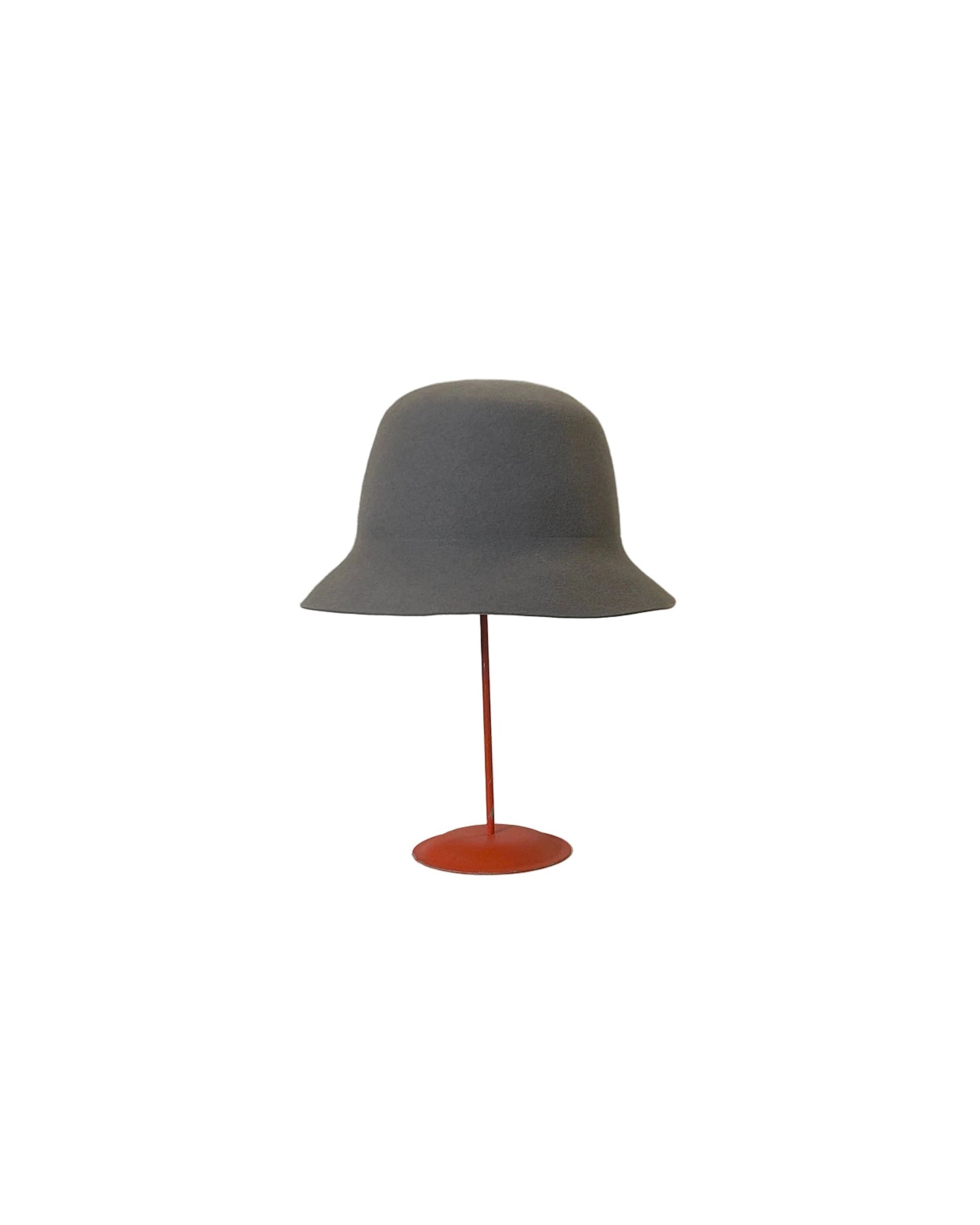 Gray Bucket Hat on a red stand against a white surface