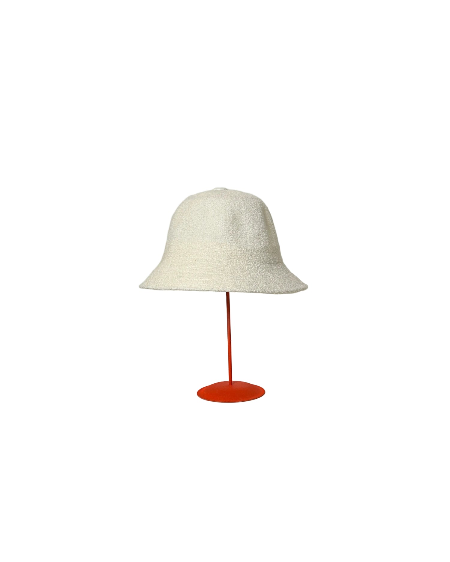White Bucket hat on a red stand against a white backdrop. 