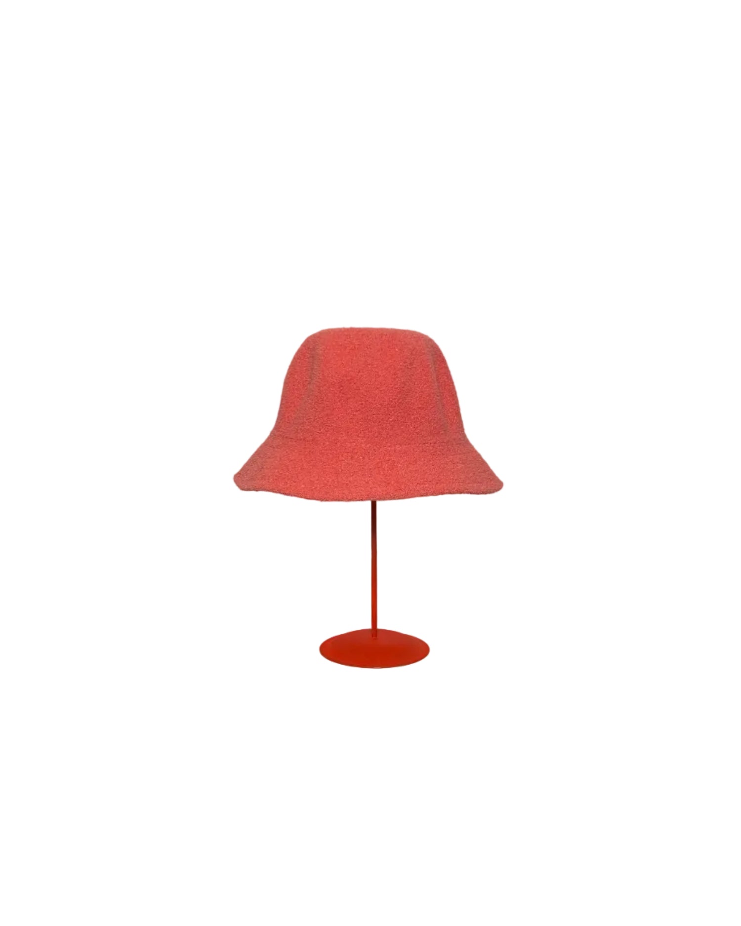Coral Bucket hat on a red stand against a white backdrop. 